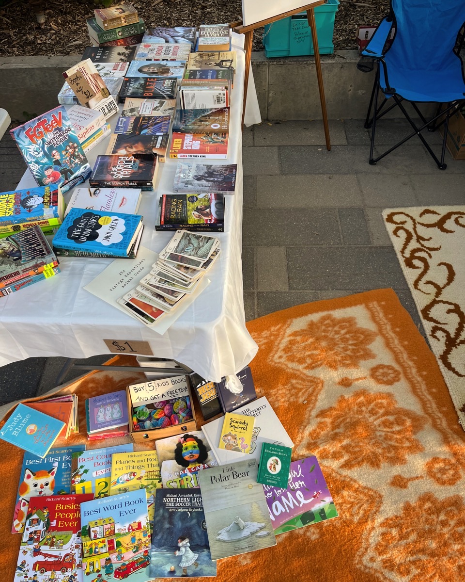 Curated used books table display at market